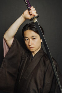 Yuki Kedoin posing with sword in hand.