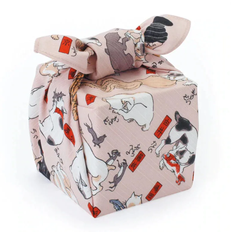 Small furoshiki wrapping cloth wrapped around a box with a cat pattern printed on it