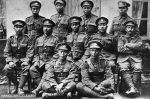 A historic black-and-white group portrait of eleven Japanese-Canadian soldiers posing in military uniforms during the First World War.