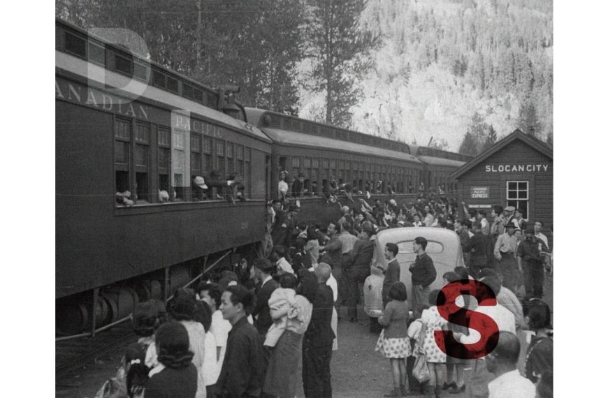 A grainy, black-and-white archival photograph of Japanese Canadians departing from the Slocan City train station. A large crowd on the platform waves to individuals leaning out of the windows of a Canadian Pacific passenger train. Large, stylized letters "D", "I", and "S" are superimposed over the scene in transparent white and bold red.