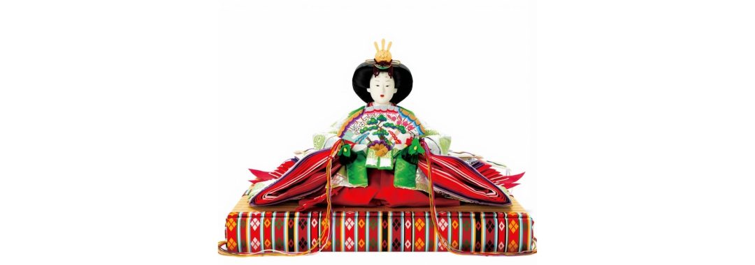 Traditional Japanese Hina doll in an elaborate multi-layered kimono and golden crown, holding a decorative fan while seated.