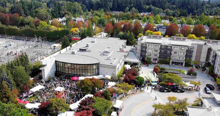 Nikkei Centre building from a birds eye view with autumn foliage in the background.