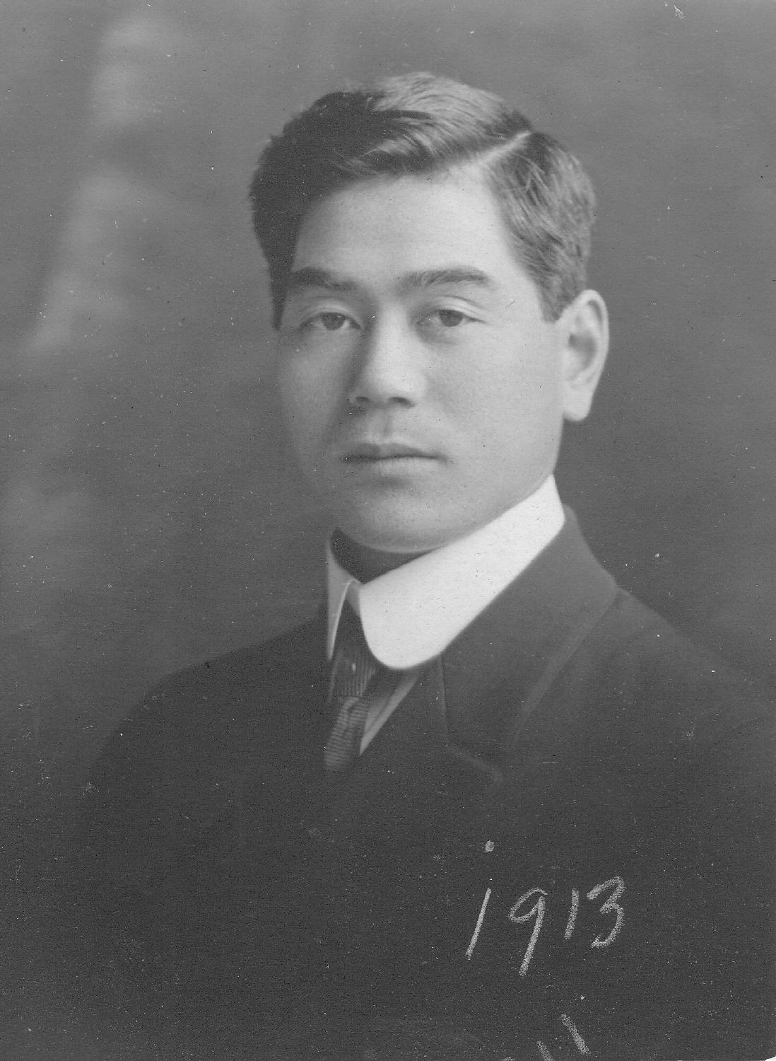 Black and white historical portrait of Saburo Shinobu in a suit, dated 1913.